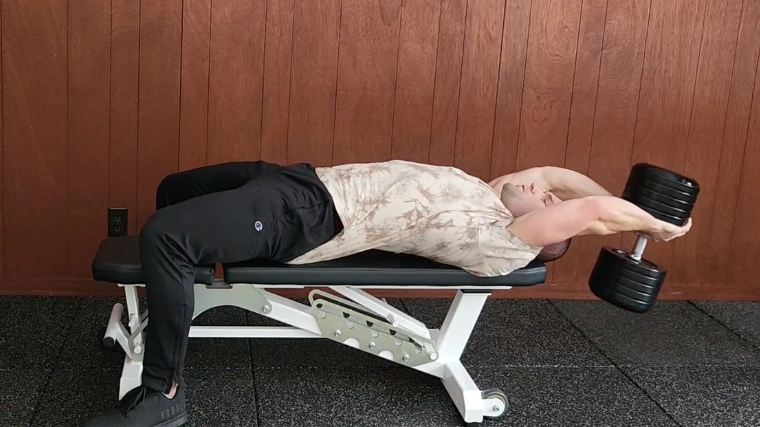 Coach Dr. Merrick Lincoln performing dumbbell pullover on flat bench