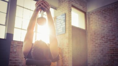 A person doing dumbbell pullovers.