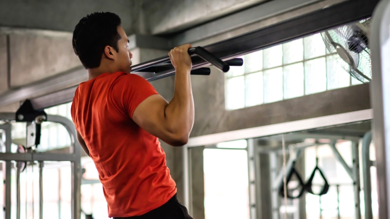 A person doing a pull up.