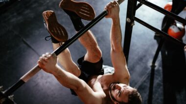 A person doing toes to bar exercise.