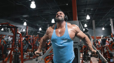 Derek Lunsford performing low-to-high cable flyes in the gym.