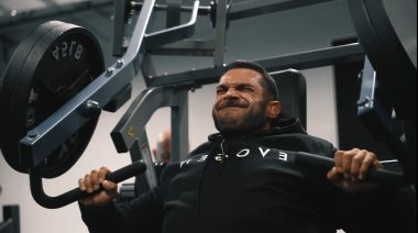 Derek Lunsford performing a machine chest press during a workout.