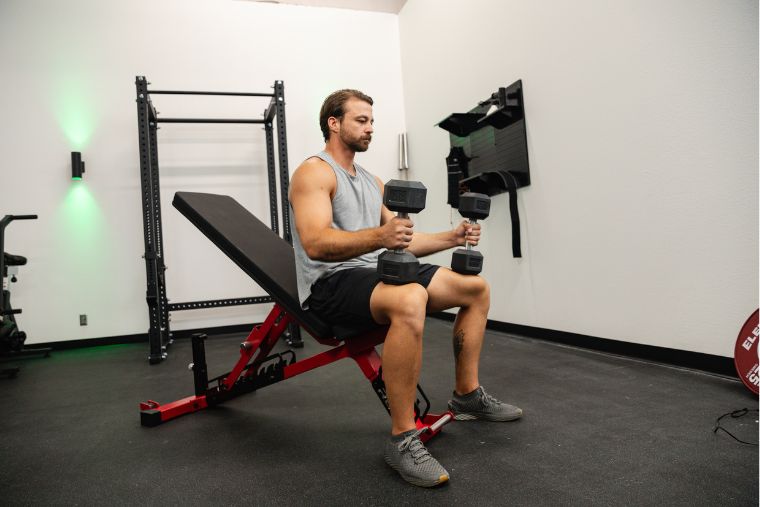 An athlete preparing to do dumbbell bench presses on the REP AB-5200 2.0