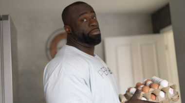 Professional bodybuilder Samson Dauda holds a carton of eggs.