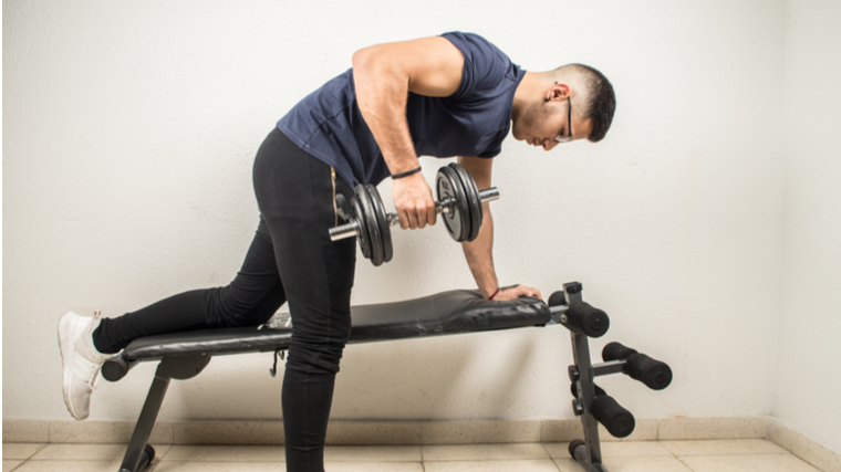 man performing dumbbell row incorrectly