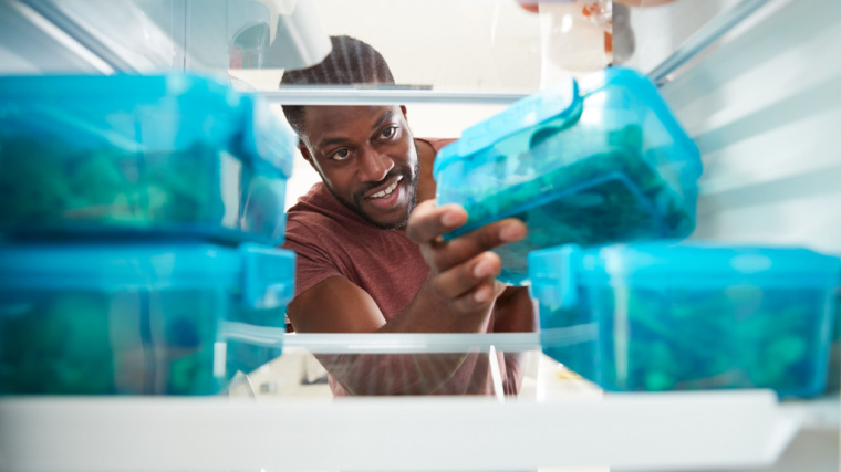 person taking packed lunch from refrigerator