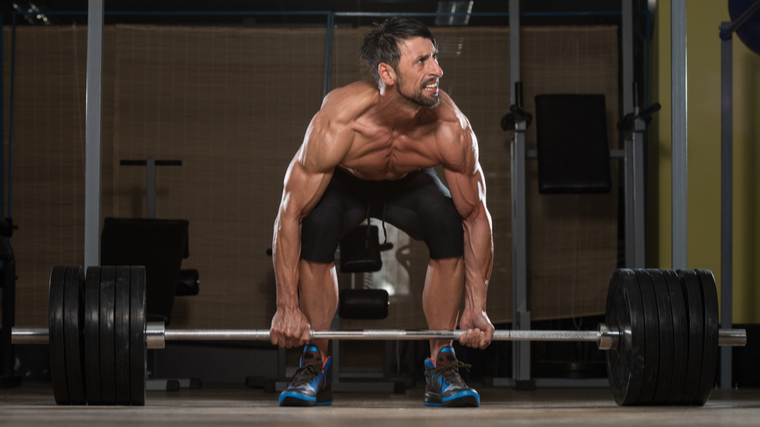 Man performing deadlift with bad form