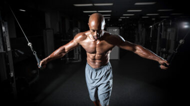 Man in gym performing cable chest exercise