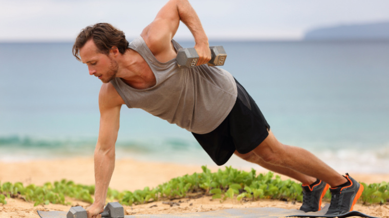 person outdoors performing dumbbell floor exercise